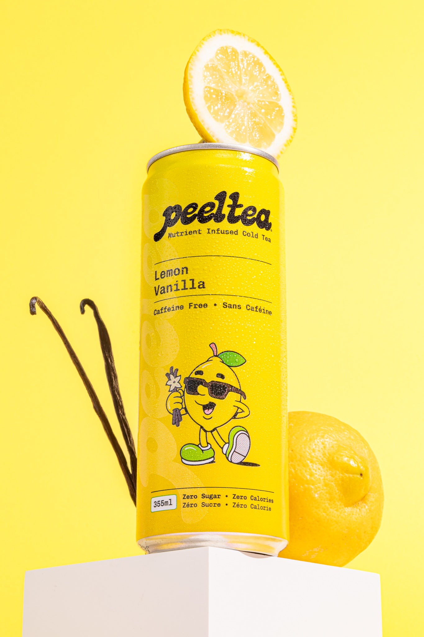 Hero image of PeelTea Lemon Vanilla nutrient-infused cold tea with fresh lemon slices and vanilla sticks.